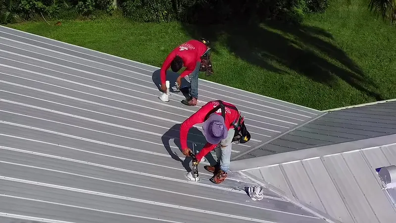 Remco crew installing a metal roof, seen from a drone