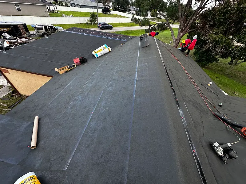 Black underlayment going down on a shingle re-roof