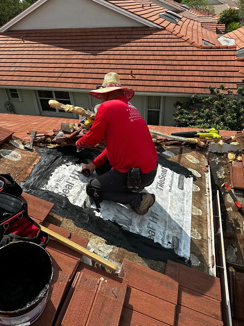 Remco roofer laying new underlayment in a tile valley